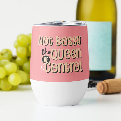 a pink and white wine tumbler next to a bottle of wine with the words not bossy the queen of control on it